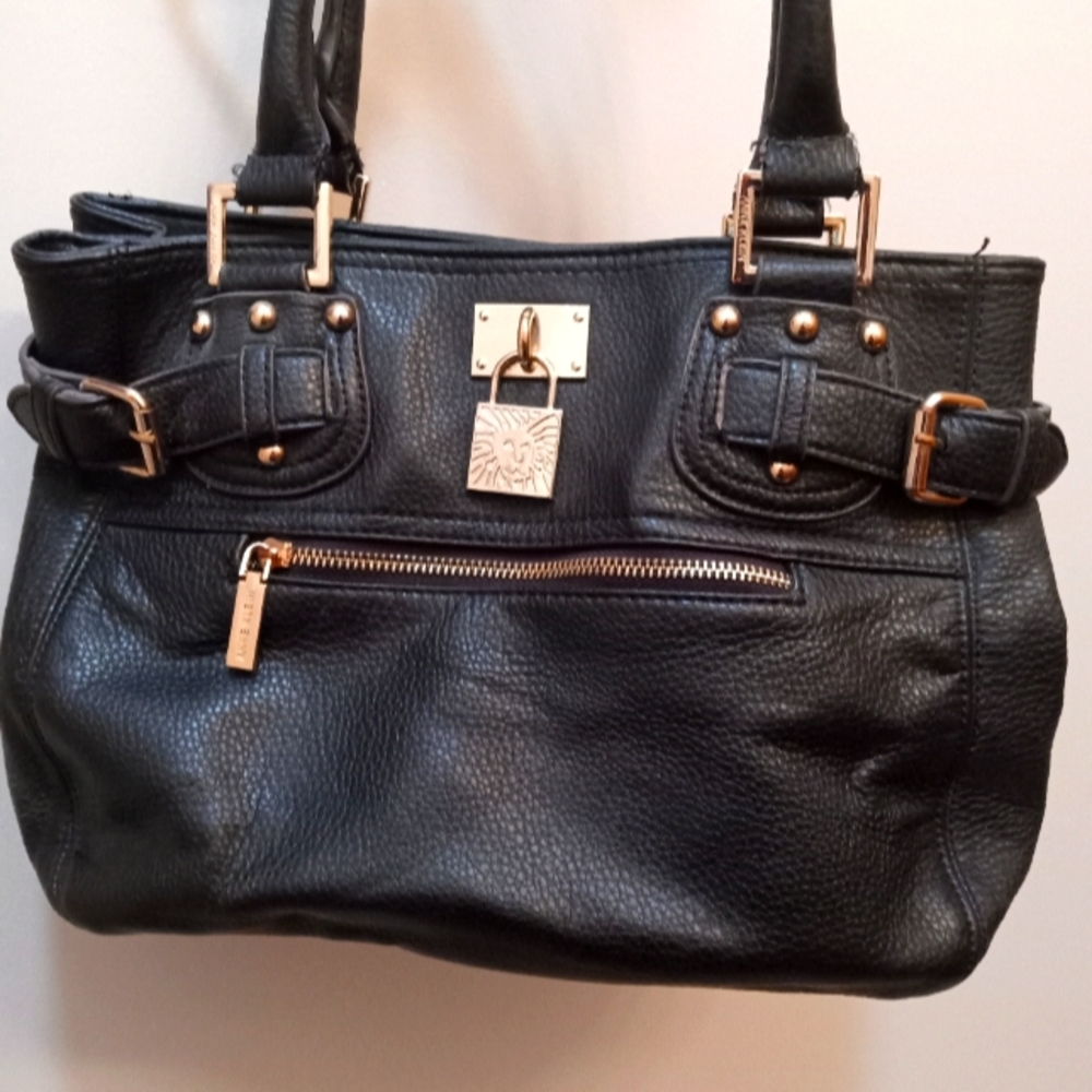 Black leather Anne Klein shoulder bag with gold accents and Burgundy interior.